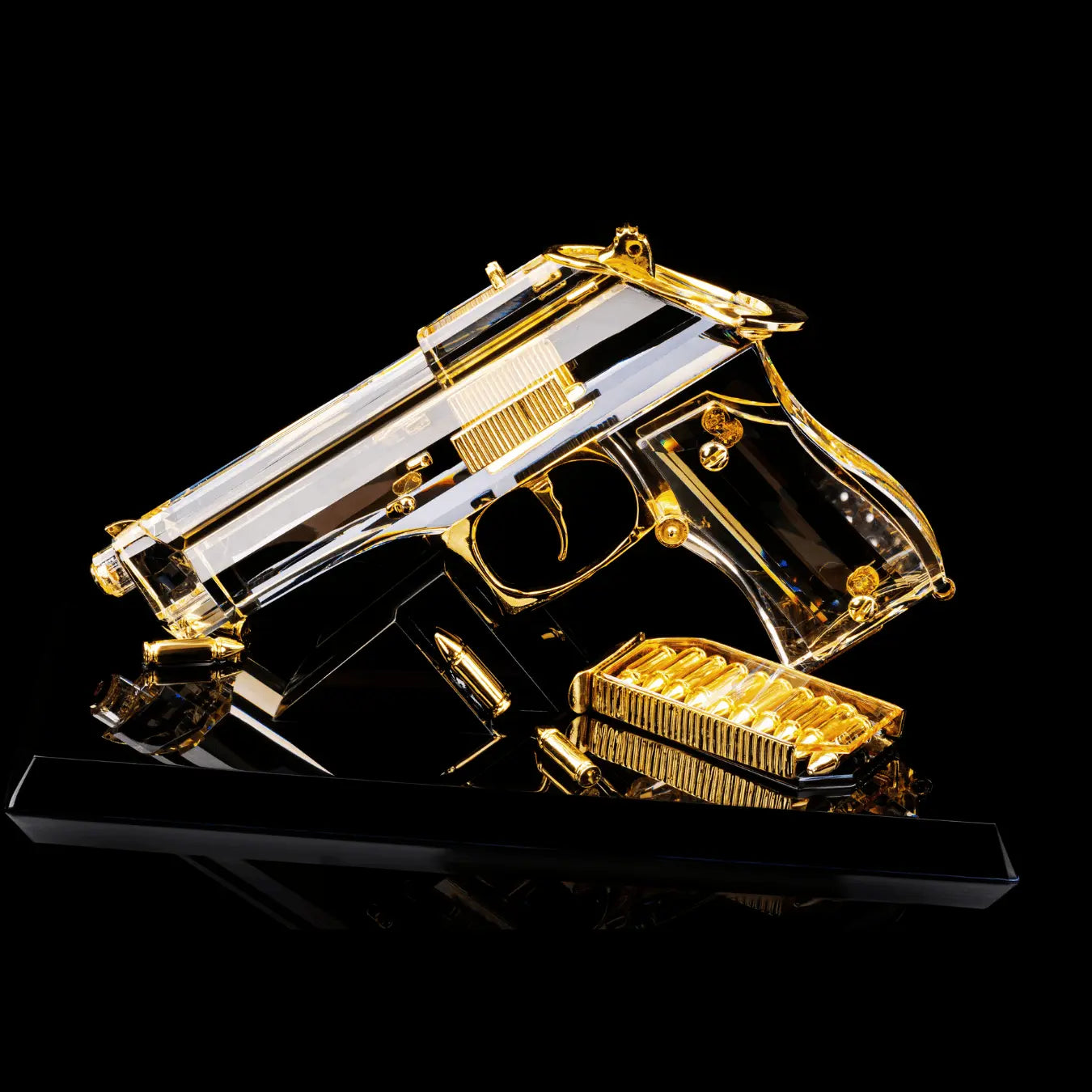 Crystal sculpture inspired by the Beretta 92FS handgun, featuring 24K gold-plated details, a 10-round magazine, and 4 gold bullets on a black base.